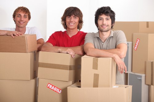 Local moving truck loading boxes and furniture near South Kensington