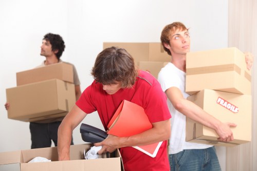Workers using safe manual handling techniques
